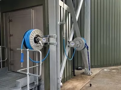 Two stainless steel hose reels installed on an elevated platform as part of the multi-point washdown system at an industrial site in Burton.